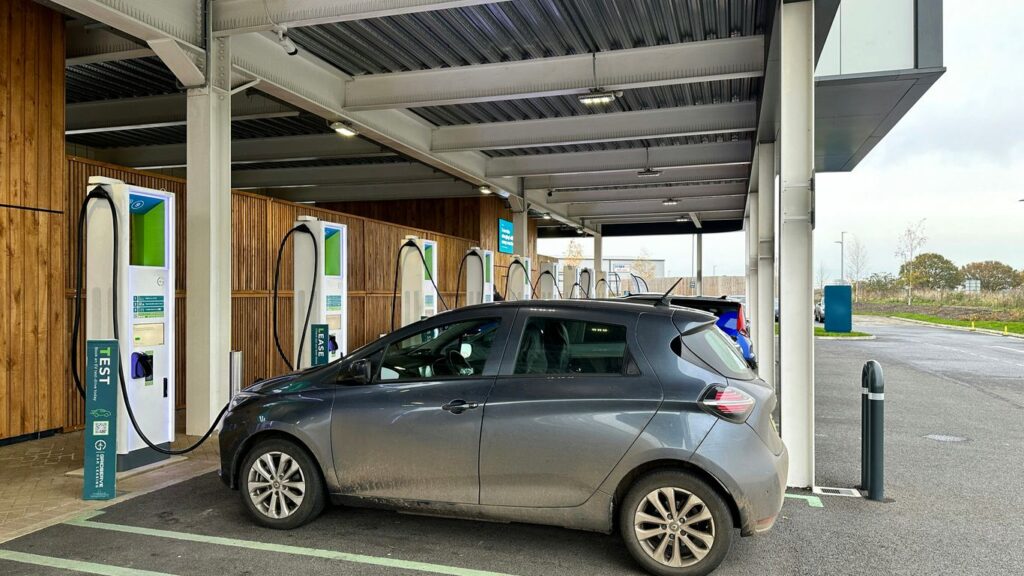 a silver car is parked at a gas station