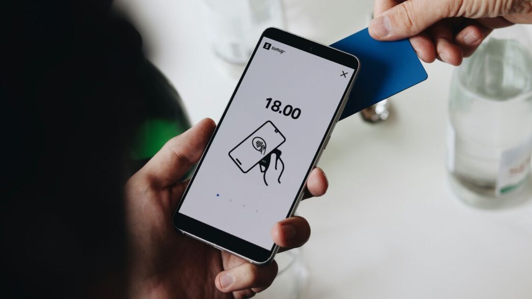 A person holding a cell phone in their hand