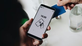 A person holding a cell phone in their hand