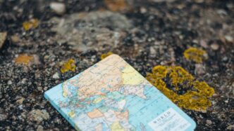 closed world map book on black surface