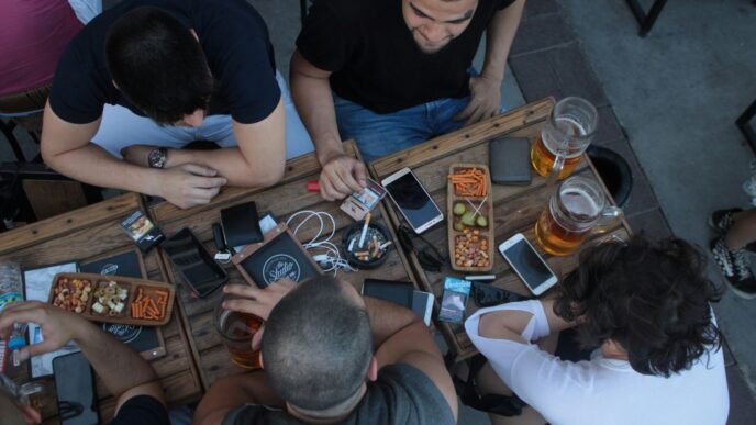 four men sitting on table while drinking