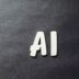 the word ai spelled in white letters on a black surface