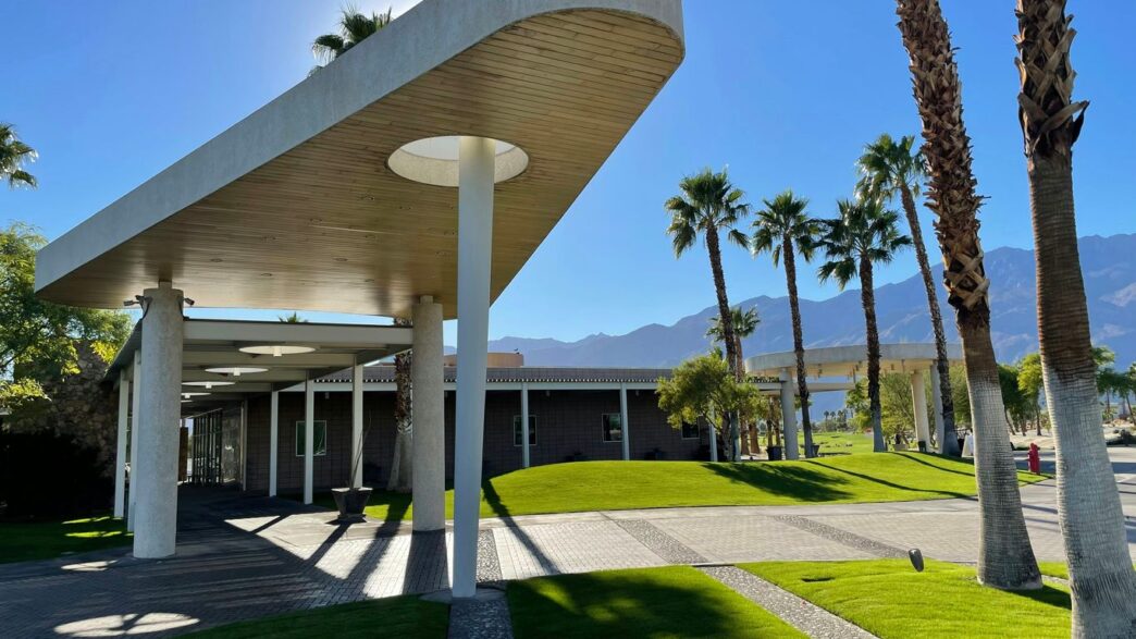 a building with palm trees in front of it