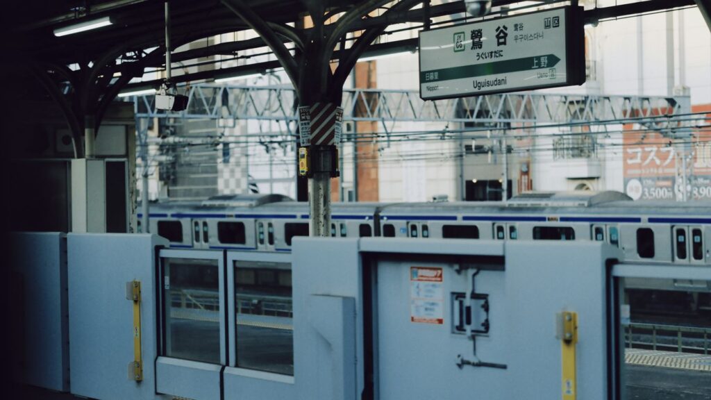 Train station platform with closed doors and train
