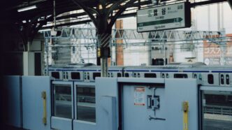 Train station platform with closed doors and train