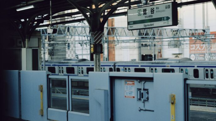 Train station platform with closed doors and train
