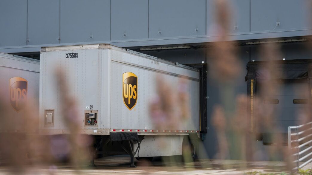 A truck is parked in front of a building