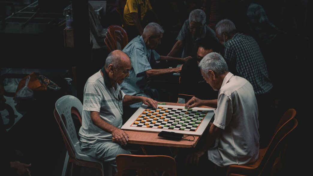a group of older men playing a game of chess