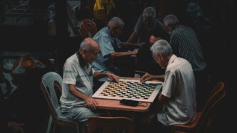 a group of older men playing a game of chess