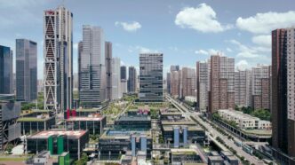 Modern city skyline with tall buildings and blue sky.