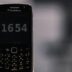 black nokia qwerty phone at 12 00