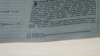 A close up of a newspaper with a clock on it