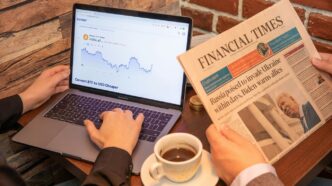 a person sitting at a table with a laptop and a cup of coffee