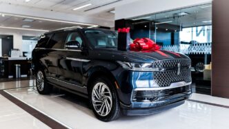 Dark blue luxury suv with red bow on hood