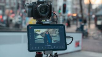 Camera and tablet on tripod filming city street