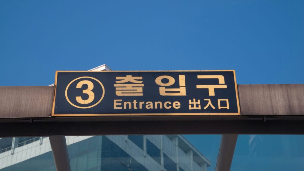 Entrance sign with korean and english text.