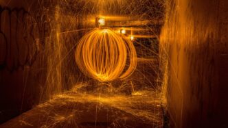 a large metal object is spinning in a tunnel
