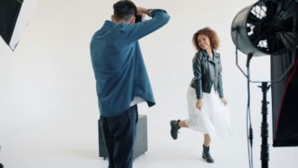 Photographer directs model during studio photoshoot
