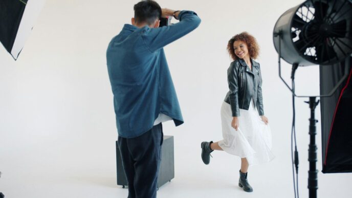 Photographer directs model during studio photoshoot