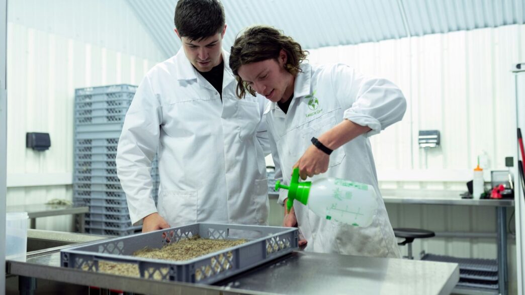 man in white chef uniform holding green bottle