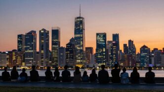 UK cityscape at dusk with silhouettes of people looking forward.