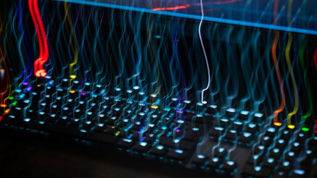 a close up of a computer keyboard with colorful lights