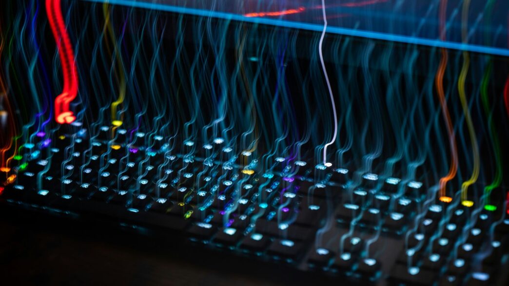 a close up of a computer keyboard with colorful lights