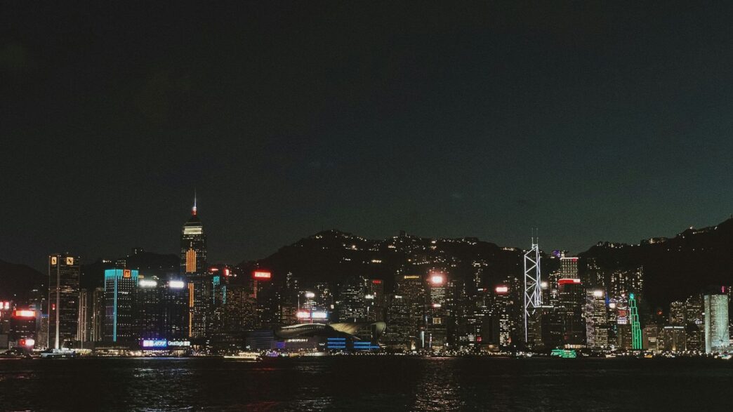 Vibrant cityscape with illuminated skyscrapers at night.