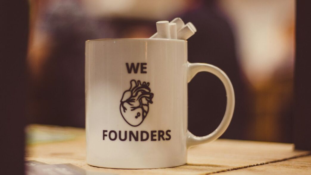 selective focus photo of we Founders heart-printed ceramic mug