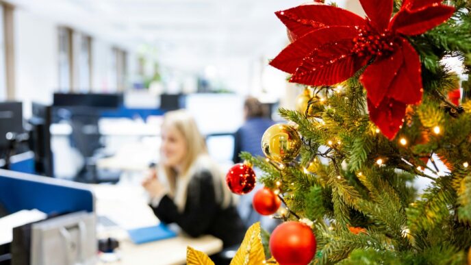 A decorated christmas tree in an office cubicle
