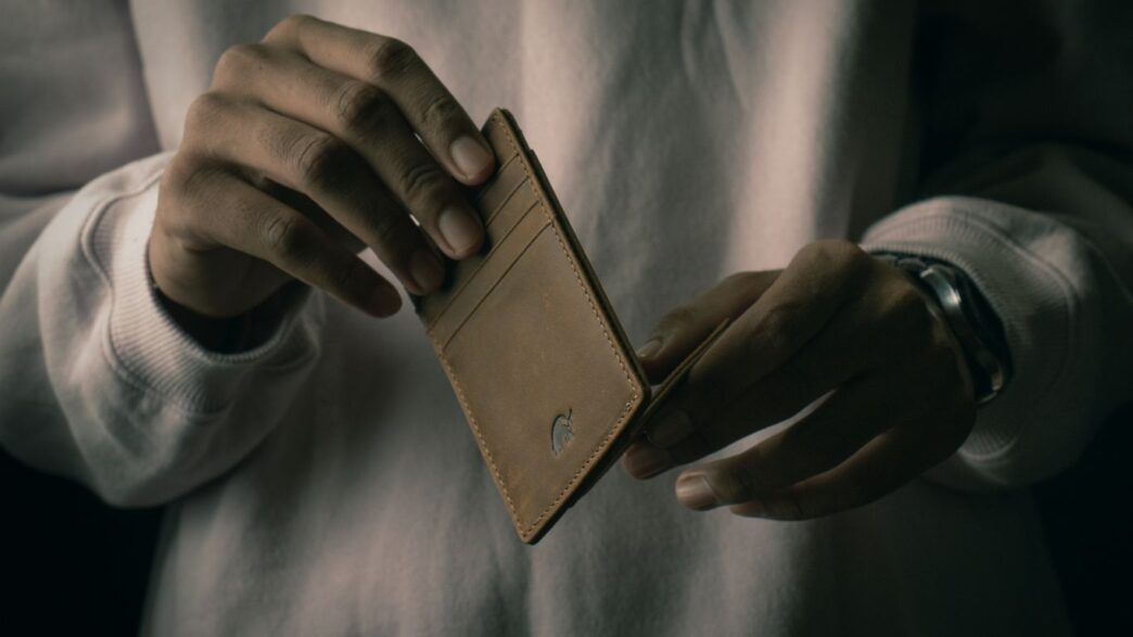 a person holding a wallet in their hand