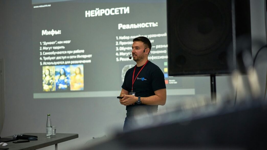 A man standing in front of a projector screen