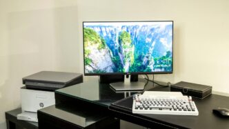 black flat screen tv turned on near white computer keyboard