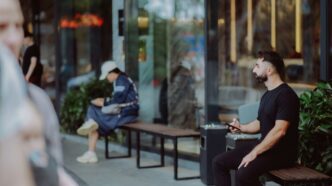Man sitting on a bench outside a building