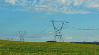 a field with power lines in the distance