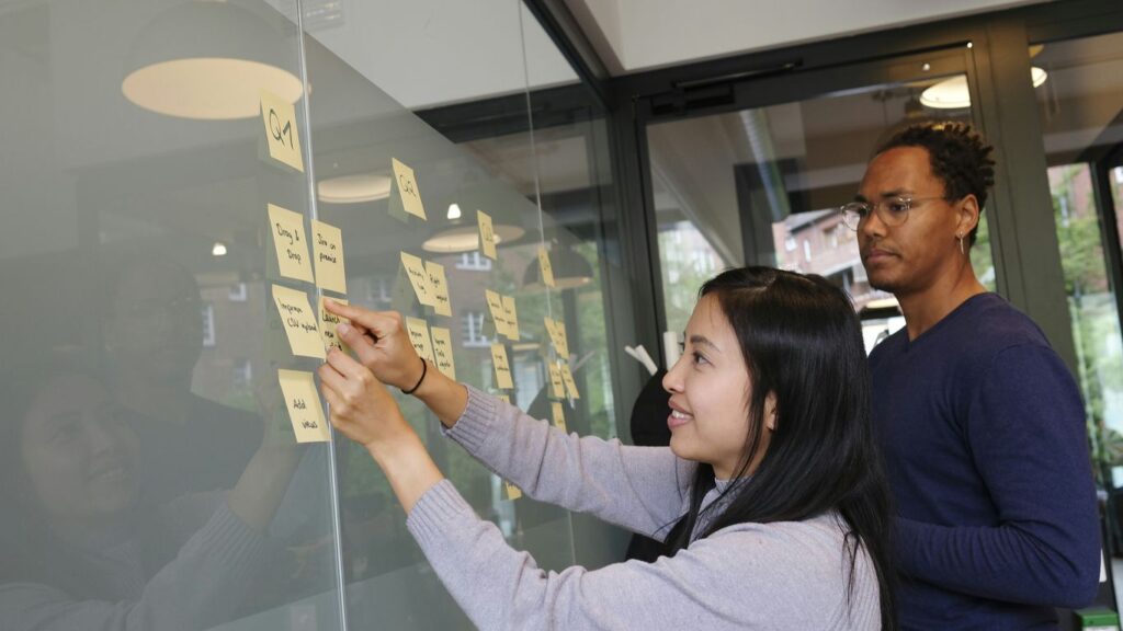 woman in gray sweater holding gold iphone 6