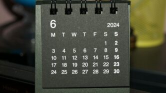 A black and white calendar sitting on top of a table