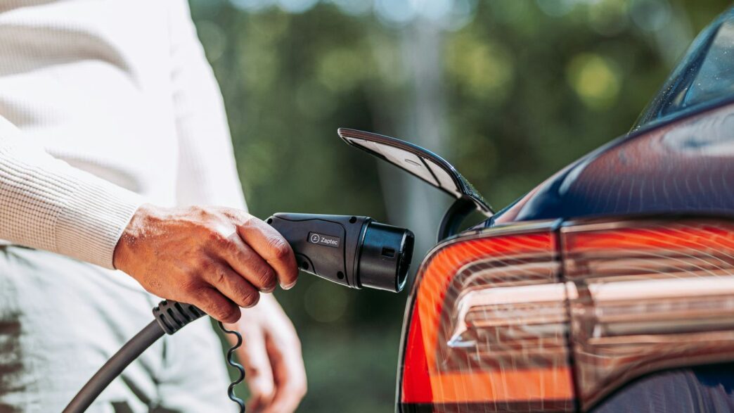 A man pumping gas into his car at a gas station