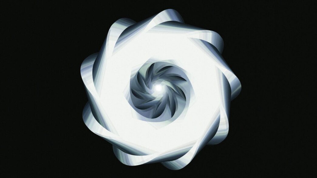 A luminous, spiraling design against black.