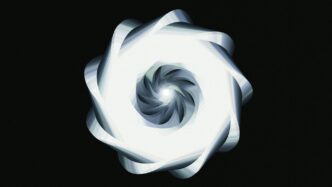 A luminous, spiraling design against black.