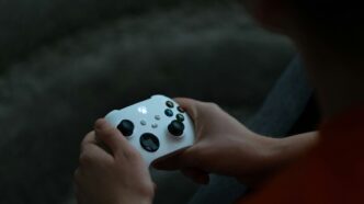 a close up of a person holding a controller