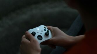 a close up of a person holding a controller
