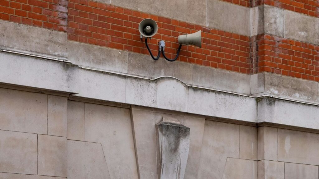 black sconce lamp on brown brick wall