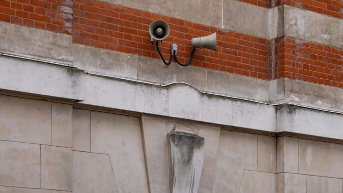 black sconce lamp on brown brick wall