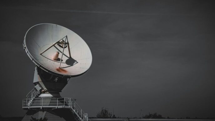 a large satellite dish sitting on top of a metal platform