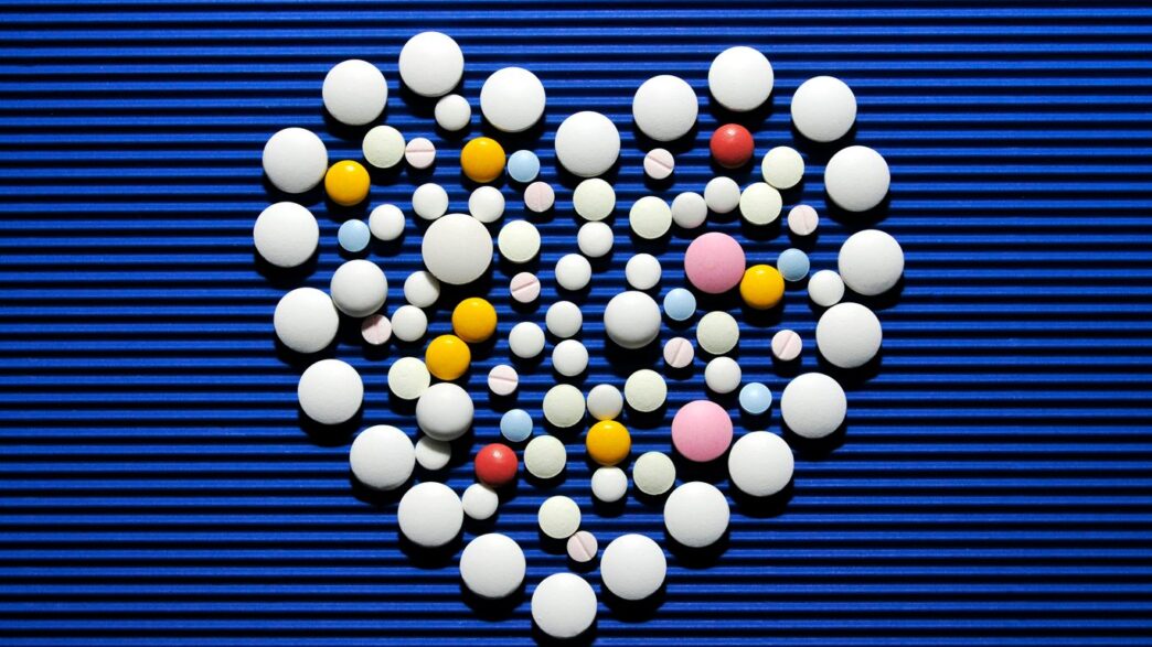 A heart made out of pills on a blue background