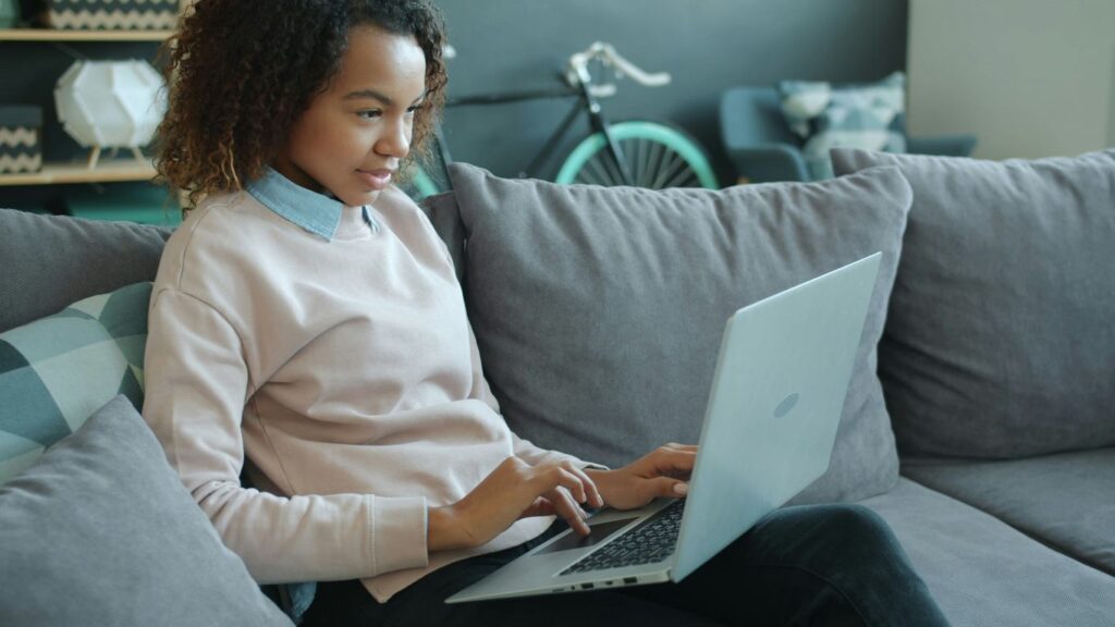 Woman working on a laptop on a couch