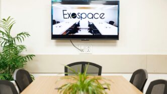 A conference room has a TV screen.