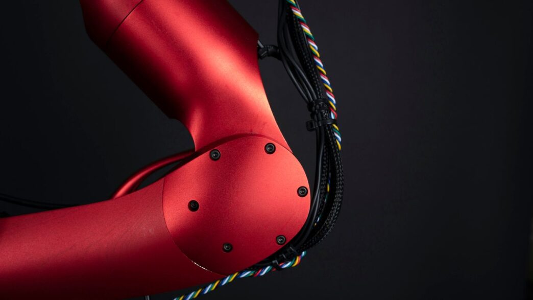 a close up of a red bike with a black background