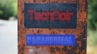 a red and blue sign on a tree